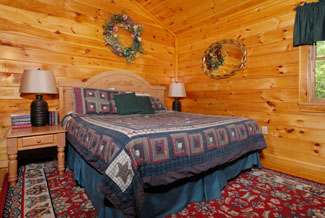 Pigeon Forge Four Bedroom Cabin That features a Big Screen Tv in the bedroom